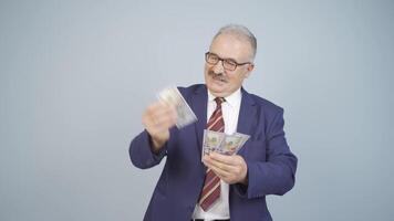 Businessman counting money looking at camera. video