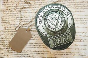 KYIV, UKRAINE - MARCH 9, 2024 US SWAT badge with dogtags on United States Constitution photo