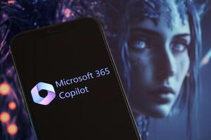 KYIV, UKRAINE - MARCH 17, 2024 Microsoft Copilot logo on iPhone display screen with background of artificial intelligence futuristic image photo