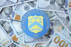 KYIV, UKRAINE - MARCH 9, 2024 US The Department of the Treasury seal on many US hundred dollar bills photo