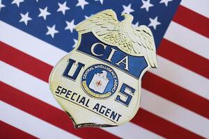 KYIV, UKRAINE - MARCH 9, 2024 US CIA Central Intelligence Agency badge on United States of America flag photo