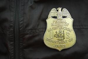 KYIV, UKRAINE - MARCH 9, 2024 US FBI Federal Bureau of Investigation badge on black jacket uniform photo