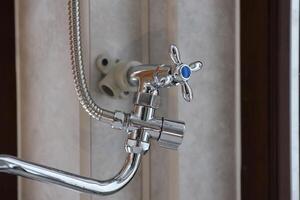 Silvery shower in modern hotel bathroom with natural light photo