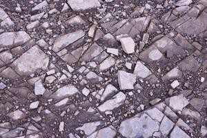 Background of shattered stony stones surface in mountain area. Texture with natural light photo