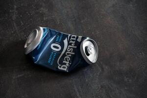 KYIV, UKRAINE - 4 MAY, 2023 Carlsberg zero alcohol or non alcohol crumpled aluminium tin can photo