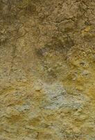 Texture of a wall of solid yellow and brown sand in a sandy quarry photo