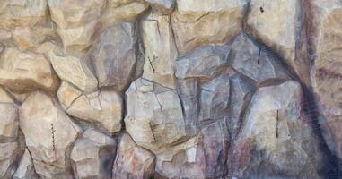 Texture of a stone wall with many big brown and grey stones armed with cement. Old castle stone wall texture background for medieval usage. Part of a stony building photo