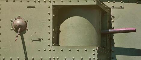 The texture of the wall of the tank, made of metal and reinforced with a multitude of bolts and rivets. Images of the covering of a combat vehicle from the Second World War with a guided machine gun photo