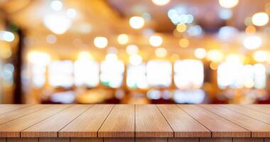 Empty wooden table top with lights bokeh on blur restaurant background. photo