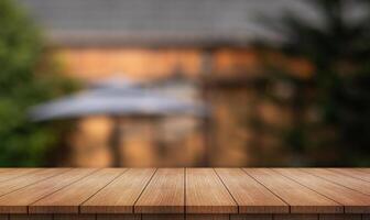 Empty wooden table top with lights bokeh on blur restaurant background. photo