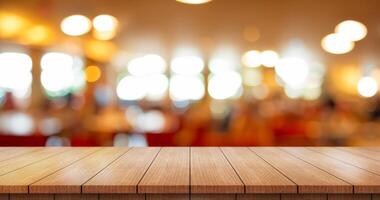 Empty wooden table top with lights bokeh on blur restaurant background. photo