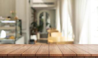 Empty wooden table top with lights bokeh on blur restaurant background. photo