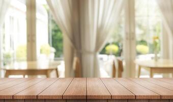 Empty wooden table top with lights bokeh on blur restaurant background. photo