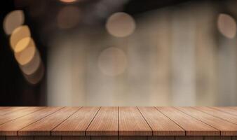 Empty wooden table top with lights bokeh on blur restaurant background. photo