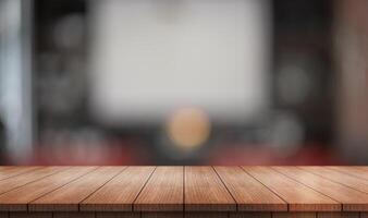 Empty wooden table top with lights bokeh on blur restaurant background. photo