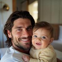 Father Holding a Baby with Affection in a Home Setting photo