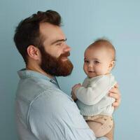 Father holding a baby with affection suitable for family or parenting content photo