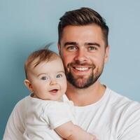 sonriente padre participación un contento bebé en contra un azul fondo, adecuado para familia o paternidad conceptos foto