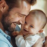 Smiling father holding and bonding with cheerful baby photo