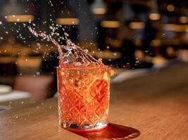 Red brown cocktail with splashes in nightclub photo