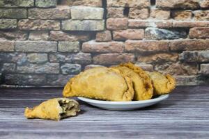 Typical Argentine fried meat empanadas, on rustic background photo