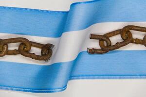 Broken chains on the Argentine flag. Concept of revolution and national independence photo