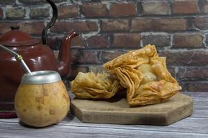 Plate of fried sweet potato and quince pastries. traditional in the Argentine national holidays photo