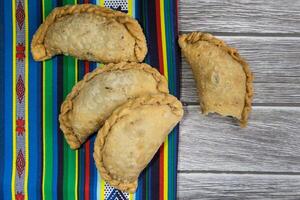 Typical Argentine fried meat empanadas, on rustic background photo