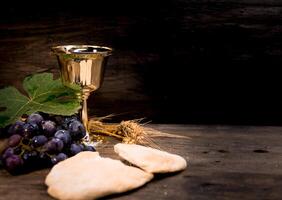 sour bread, wine, grapes and wheat symbol of Christian communion photo