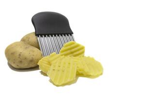 A stainless steel wavy cutter, with a black handle. To cut potatoes, sweet potatoes, fruits and vegetables. Isolated on a white background. photo