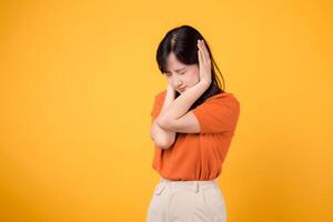 Unhappy asian woman 30s person facing noise problem, holding ear in pain. Studio portrait reflecting stress and discomfort. photo