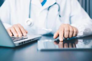 Female doctor using her digital tablet for employees management, hospital workflow and clinic staff solution on software or app. in the office. photo