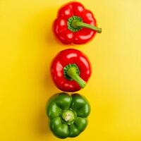 colorful bell peppers on yellow background photo