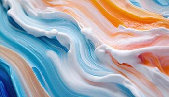 a close up of a colorful liquid with white, orange, and blue swirls photo