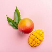 mango and mango cubes on a pink background photo