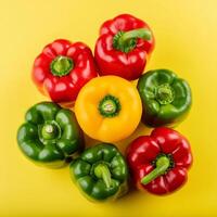 colorful bell peppers on yellow background photo