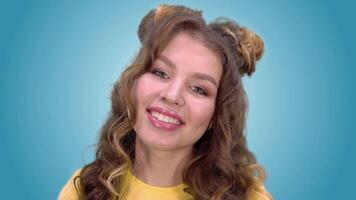 Beautiful young girl in a yellow vest with a good mood is smiling while looking into the camera. close-up. green screen video