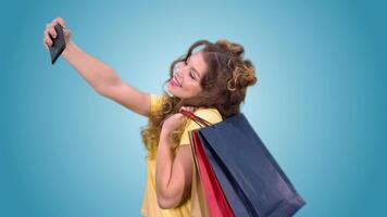 beautiful young girl in a yellow vest with styling after shopping makes selfie and smiling. green screen video