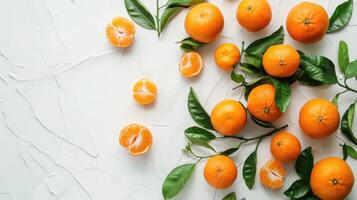 Fresh ripe tangerines and leaves on light white background. Flat lay, top view, copy space. photo