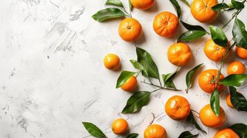 Fresh ripe tangerines and leaves on light white background. Flat lay, top view, copy space. photo