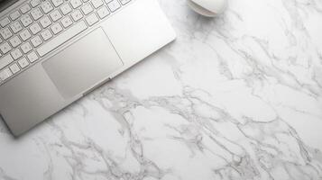Notebook with keyboard on white marble table. Top view of modern stylish workplace with laptop computer. Copy space. Flat lay. photo