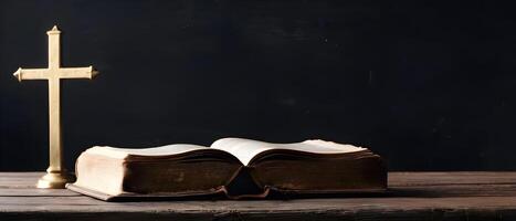 Old holy bible with golden cross on old rustic vintage wooden table and black wall. Church faith Christian background banner panorama photo