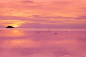 Seascapes of beautiful sunset on the sea beach with pink sky on vacation photo