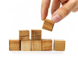 Hand putting and stacking blank wooden cubes on table with copy space can add text or icon photo