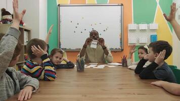 africano americano professor ensina uma grupo do crianças matemática dentro a sala de aula. escola para crianças, ensino adolescentes, ganho conhecimento, aprender a linguagem. video