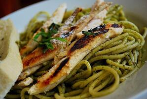 Pesto Pasta Close Up on a White Plate photo