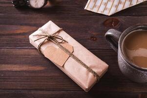 Father's day craft gift with cardboard heart next to coffee mug on wooden table photo