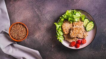 Homemade buckwheat pancakes with fresh vegetables and herbs on a plate top view web banner photo