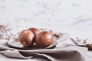 Happy Easter home made naturally colored eggs on a plate on a napkin photo