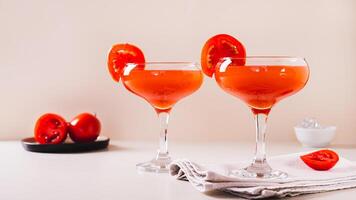 Trendy tomato martini cocktail in glasses on the table web banner photo